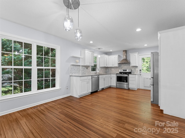 690 Mountain Rd, Hendersonville, NC 28791 - kitchen featuring appliances with stainless steel finishes, wall chimney range hood, open shelves, backsplash, and white cabinets