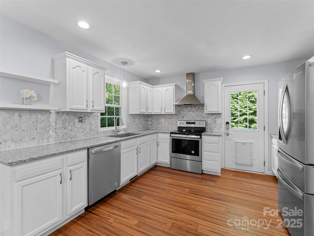 690 Mountain Rd, Hendersonville, NC 28791 - kitchen featuring stainless steel appliances, wall chimney range hood, white cabinetry, and recessed lighting