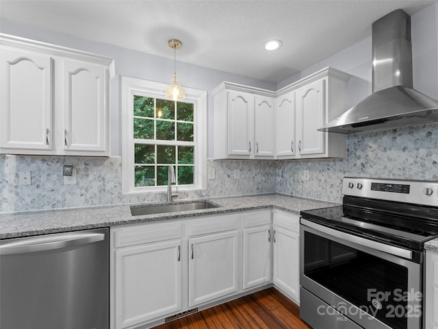 690 Mountain Rd, Hendersonville, NC 28791 - kitchen with stainless steel appliances, wall chimney range hood, white cabinets, dark wood-type flooring, and tasteful backsplash