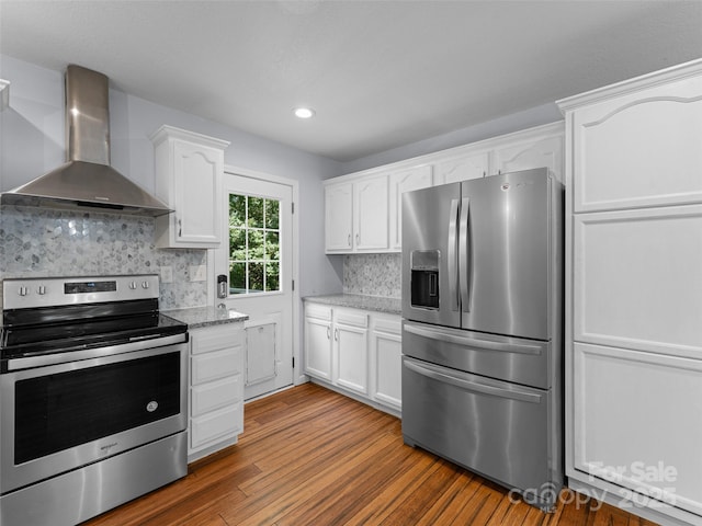 690 Mountain Rd, Hendersonville, NC 28791 - kitchen featuring appliances with stainless steel finishes, wall chimney range hood, white cabinets, wood finished floors, and recessed lighting