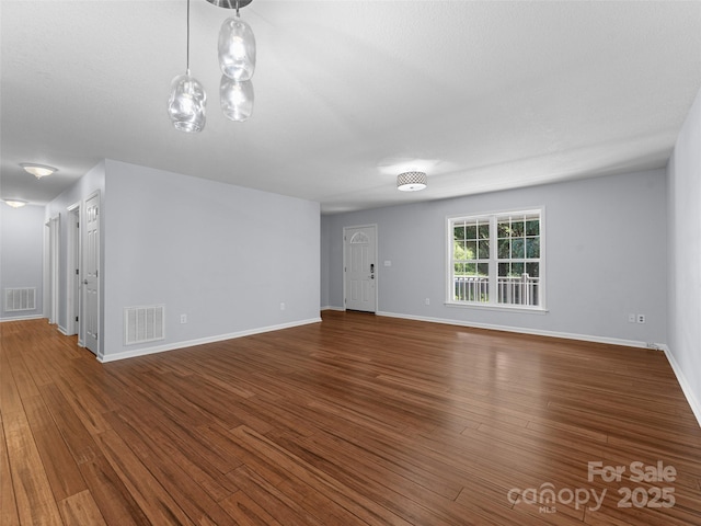 690 Mountain Rd, Hendersonville, NC 28791 - unfurnished living room featuring wood finished floors and baseboards