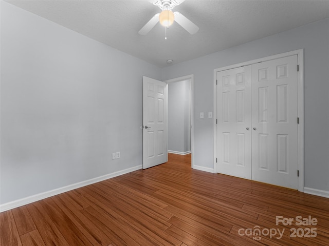 690 Mountain Rd, Hendersonville, NC 28791 - unfurnished bedroom featuring wood finished floors, a closet, and a ceiling fan