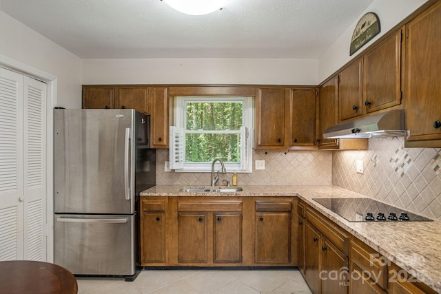 102 Boyd Dr Unit 7A, Flat Rock, NC 28731 - kitchen featuring freestanding refrigerator, under cabinet range hood, black electric cooktop, light tile patterned floors, and backsplash