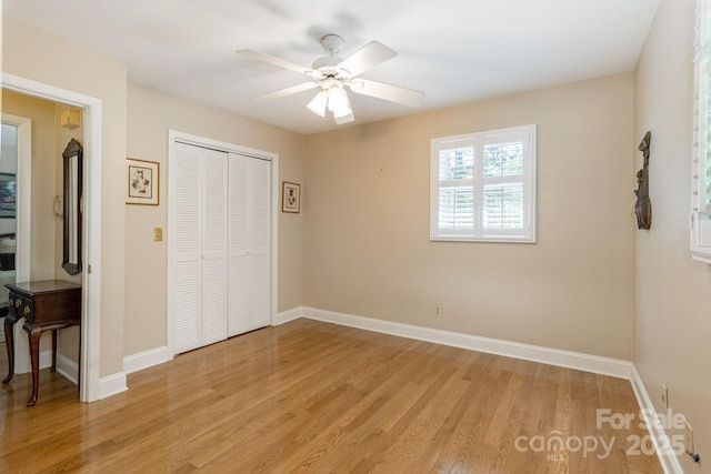 102 Boyd Dr Unit 7A, Flat Rock, NC 28731 - unfurnished bedroom featuring light wood-style floors, a closet, and a ceiling fan