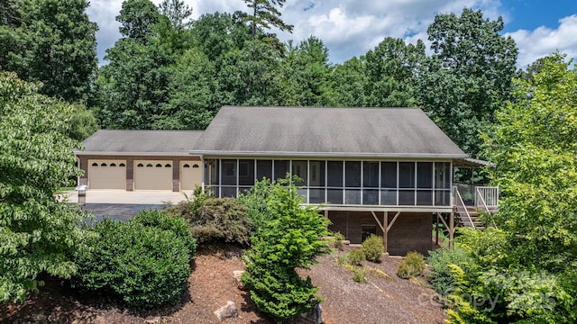 2066 Waterford Way, Morganton, NC 28655 - ranch-style house featuring a sunroom, a garage, stairway, and driveway
