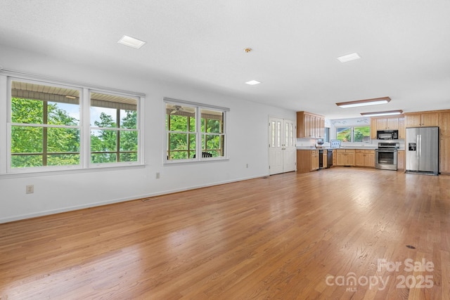 2066 Waterford Way, Morganton, NC 28655 - unfurnished living room featuring light wood-style floors and baseboards