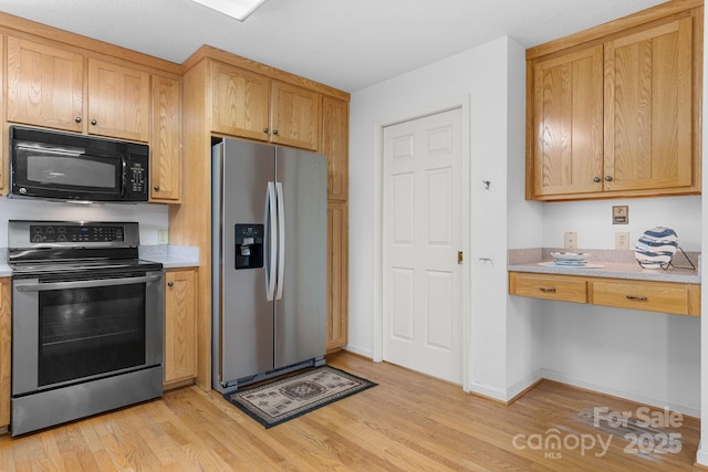 2066 Waterford Way, Morganton, NC 28655 - kitchen featuring appliances with stainless steel finishes, light wood-style flooring, and light countertops