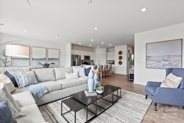 2589 Blue Sky Meadows Dr, Monroe, NC 28110 - living area featuring light wood-style flooring and recessed lighting