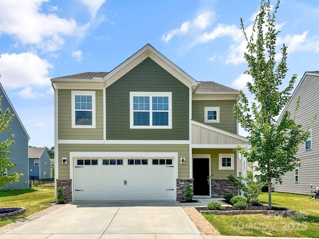 2807 Oldfield Dr, Monroe, NC 28110 - craftsman house featuring concrete driveway, stone siding, an attached garage, and a front yard