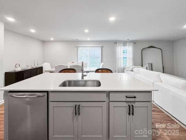 2807 Oldfield Dr, Monroe, NC 28110 - kitchen with dishwasher, open floor plan, wood finished floors, an island with sink, and light countertops