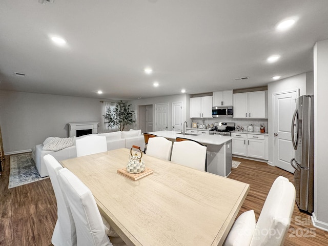 2807 Oldfield Dr, Monroe, NC 28110 - dining room featuring recessed lighting, a fireplace, and dark wood-style floors
