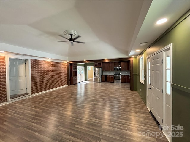 5335 NC-152 Hwy W, China Grove, NC 28023 - unfurnished living room with brick wall, dark wood-type flooring, ceiling fan, and recessed lighting