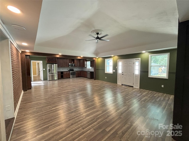 5335 NC-152 Hwy W, China Grove, NC 28023 - unfurnished living room featuring dark wood-style flooring, a ceiling fan, and a tray ceiling