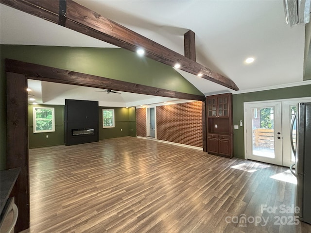 5335 NC-152 Hwy W, China Grove, NC 28023 - unfurnished living room with a glass covered fireplace, ceiling fan, beam ceiling, plenty of natural light, and wood finished floors