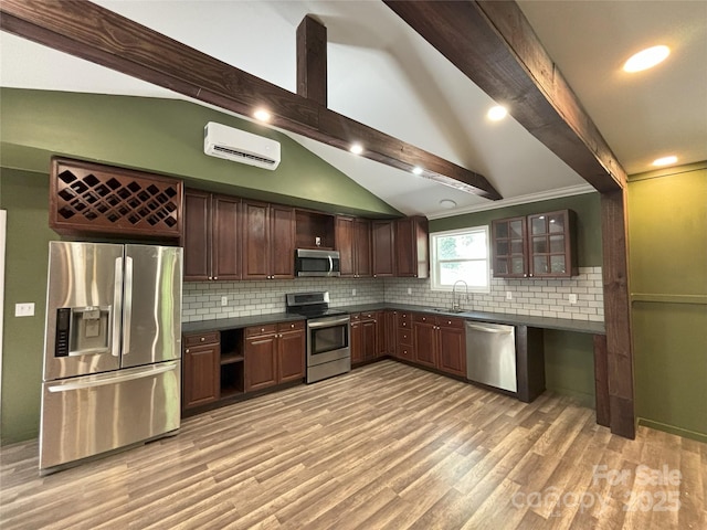 5335 NC-152 Hwy W, China Grove, NC 28023 - kitchen with appliances with stainless steel finishes, an AC wall unit, dark countertops, backsplash, and light wood finished floors