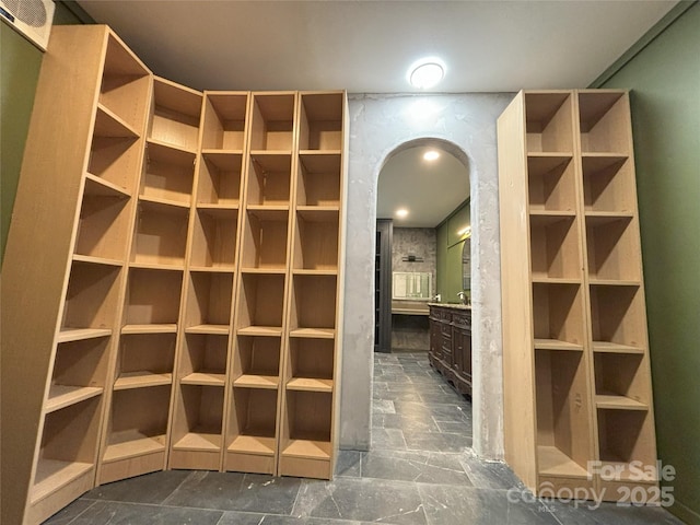 5335 NC-152 Hwy W, China Grove, NC 28023 - walk in closet with arched walkways and dark stone finish flooring