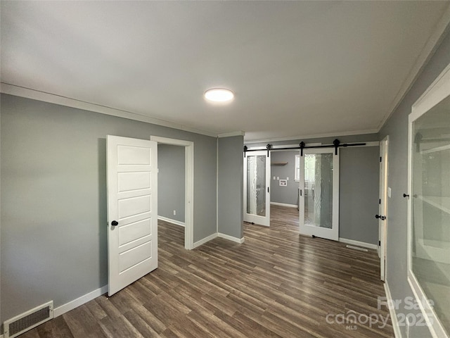 5335 NC-152 Hwy W, China Grove, NC 28023 - unfurnished room featuring crown molding, a barn door, and dark wood-type flooring