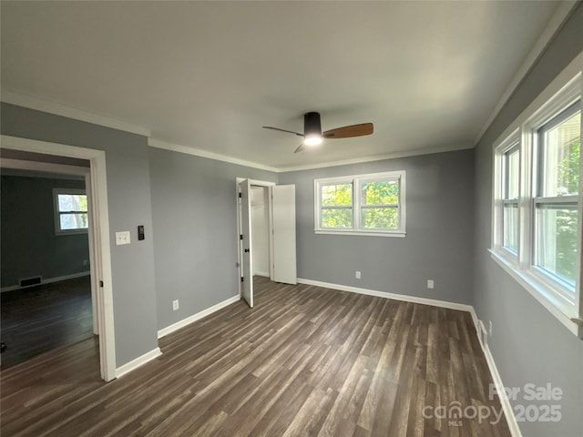 5335 NC-152 Hwy W, China Grove, NC 28023 - unfurnished bedroom featuring dark wood-type flooring, multiple windows, ornamental molding, and a ceiling fan