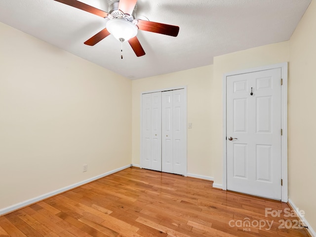 1411 Kensington Rd Unit C-1, Hendersonville, NC 28791 - unfurnished bedroom featuring light wood-style flooring, a closet, and a ceiling fan