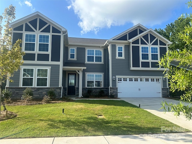 1700 Honey Trl, Monroe, NC 28112 - view of front of home featuring concrete driveway, stone siding, a garage, and a front yard
