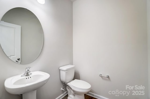 1700 Honey Trl, Monroe, NC 28112 - half bathroom with a sink and wood finished floors