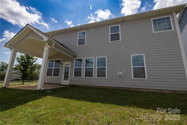 128 Carolina Ash Ln, Mooresville, NC 28117 - rear view of house featuring a lawn and a patio area