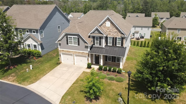 128 Carolina Ash Ln, Mooresville, NC 28117 - view of front of home with stone siding, a standing seam roof, concrete driveway, a metal roof, and an attached garage