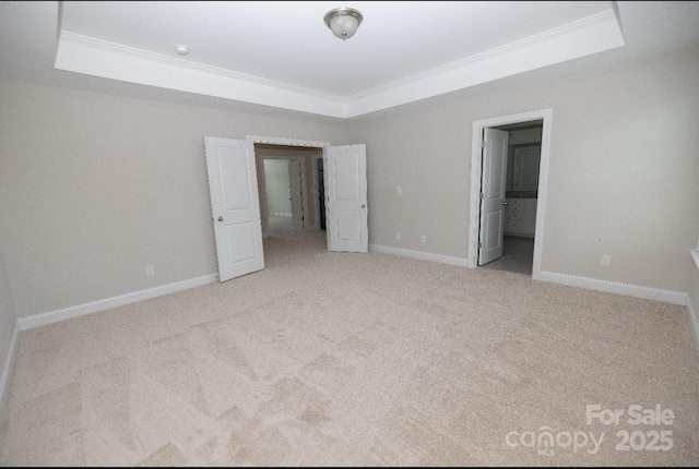 128 Carolina Ash Ln, Mooresville, NC 28117 - unfurnished bedroom featuring a tray ceiling, ornamental molding, carpet flooring, and ensuite bathroom