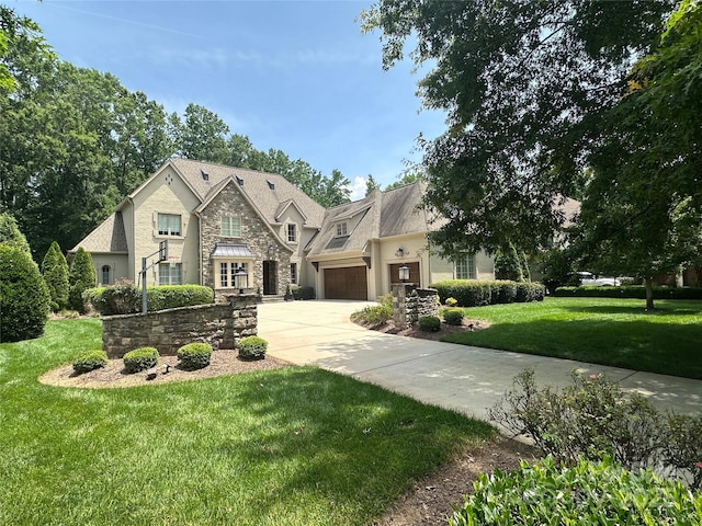 7816 Clovervale Dr, Waxhaw, NC 28173 - french country home with stone siding, driveway, a front yard, an attached garage, and stucco siding