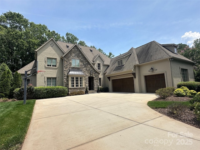 7816 Clovervale Dr, Waxhaw, NC 28173 - french provincial home featuring stone siding, concrete driveway, an attached garage, a shingled roof, and stucco siding