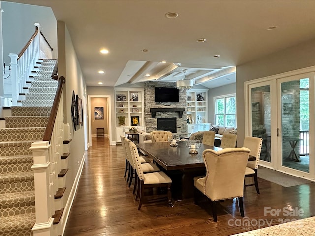 7816 Clovervale Dr, Waxhaw, NC 28173 - dining room with dark wood-style floors, a fireplace, built in shelves, recessed lighting, and stairs