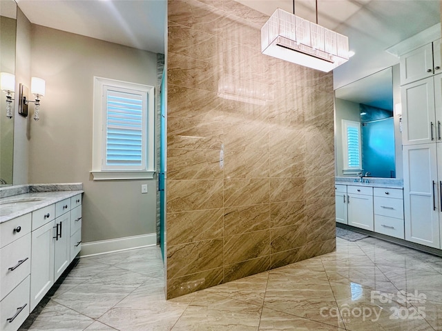 7816 Clovervale Dr, Waxhaw, NC 28173 - bathroom with marble look tiles, two vanities, and a walk in shower