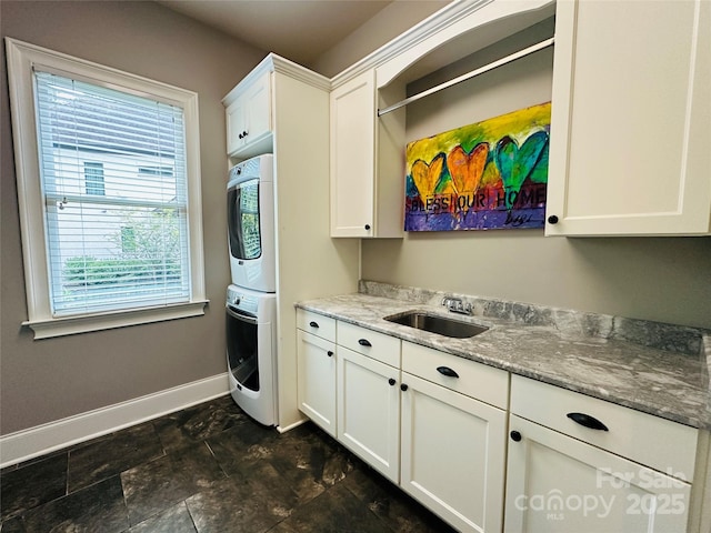 7816 Clovervale Dr, Waxhaw, NC 28173 - laundry room featuring cabinet space and estacked washer and dryer