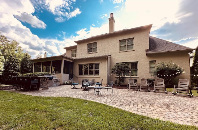 7816 Clovervale Dr, Waxhaw, NC 28173 - back of property featuring a patio area, a yard, a chimney, and a sunroom