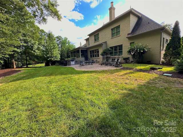 7816 Clovervale Dr, Waxhaw, NC 28173 - rear view of house featuring a patio area, a yard, a chimney, and brick siding