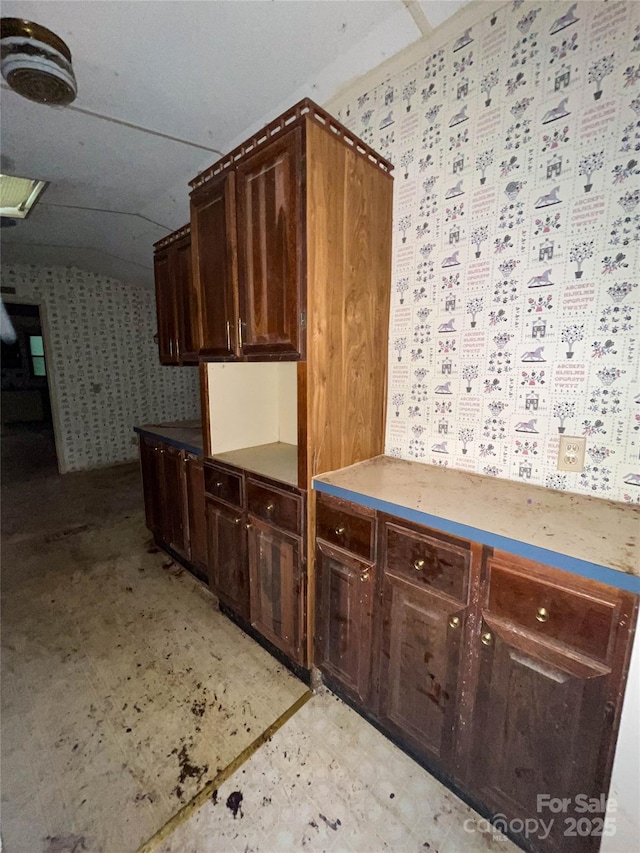 916 Steep Hill Rd, Belmont, NC 28012 - kitchen featuring wallpapered walls, light flooring, and dark brown cabinets