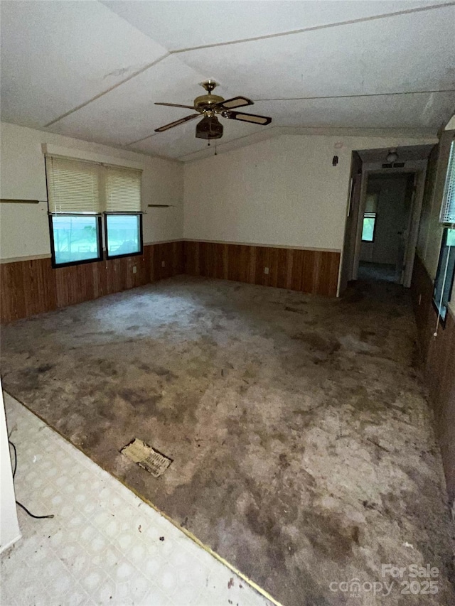 916 Steep Hill Rd, Belmont, NC 28012 - unfurnished room with a wainscoted wall, wood walls, ceiling fan, and lofted ceiling