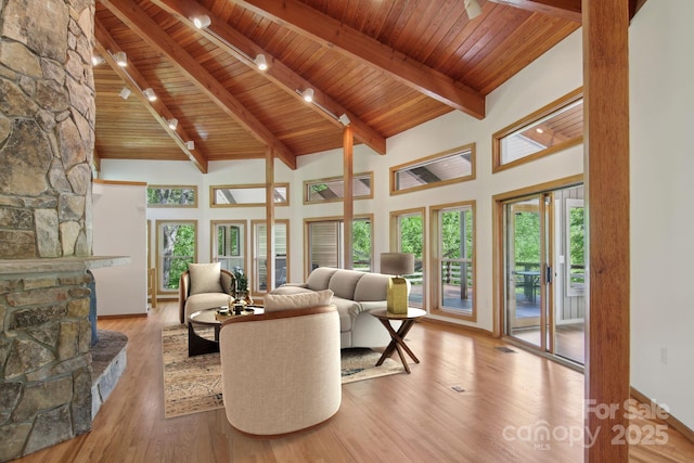 295 Dills Rd, Bryson City, NC 28713 - living room with a wood ceiling with exposed beams, high vaulted ceiling, healthy amount of natural light, a fireplace, and wood finished floors