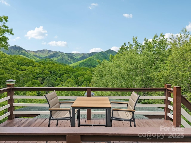 295 Dills Rd, Bryson City, NC 28713 - deck with outdoor dining area, a mountain view, and a wooded view