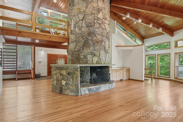 295 Dills Rd, Bryson City, NC 28713 - unfurnished living room with high vaulted ceiling, a fireplace, a wooden ceiling with exposed beams, wood finished floors, and plenty of natural light