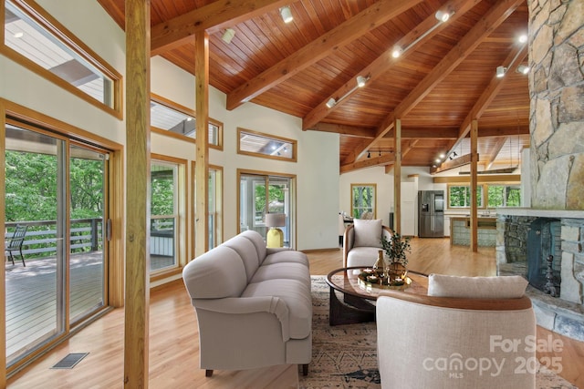 295 Dills Rd, Bryson City, NC 28713 - living room with high vaulted ceiling, a wood ceiling with exposed beams, a fireplace, and wood finished floors