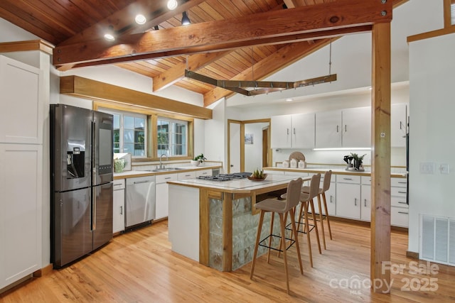 295 Dills Rd, Bryson City, NC 28713 - kitchen featuring appliances with stainless steel finishes, wooden ceiling, light countertops, white cabinetry, and light wood-style flooring