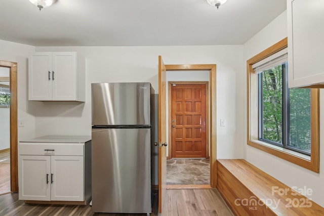 295 Dills Rd, Bryson City, NC 28713 - kitchen featuring freestanding refrigerator, wood finished floors, white cabinetry, and light countertops