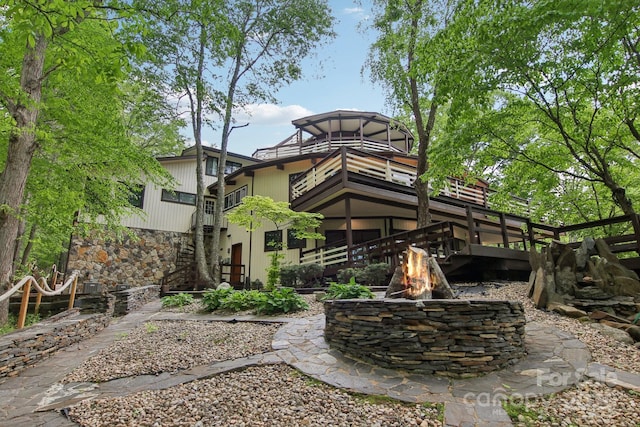 295 Dills Rd, Bryson City, NC 28713 - back of property with stairs, an outdoor fire pit, stone siding, and a balcony