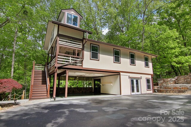 295 Dills Rd, Bryson City, NC 28713 - view of front facade featuring french doors, driveway, a carport, stairs, and view of wooded area