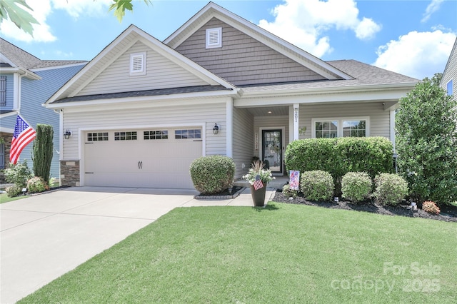 201 Fesperman Cir, Troutman, NC 28166 - craftsman house featuring a front lawn, a garage, concrete driveway, and roof with shingles