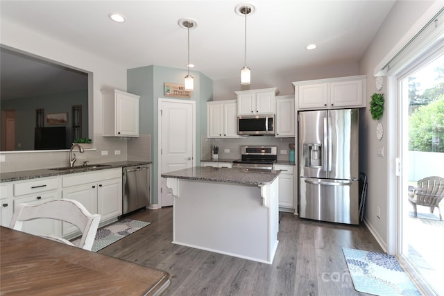 201 Fesperman Cir, Troutman, NC 28166 - kitchen with stainless steel appliances, tasteful backsplash, white cabinetry, dark wood-style flooring, and recessed lighting