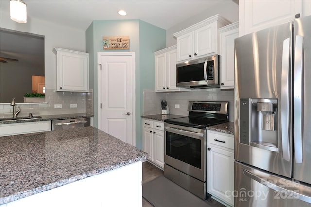201 Fesperman Cir, Troutman, NC 28166 - kitchen with appliances with stainless steel finishes, white cabinetry, tasteful backsplash, recessed lighting, and dark stone countertops