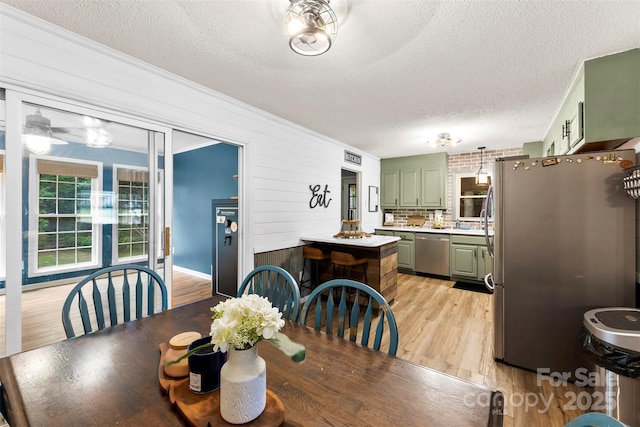 339 Deep Forest Ct, Gastonia, NC 28056 - dining room with a textured ceiling and light wood-style floors
