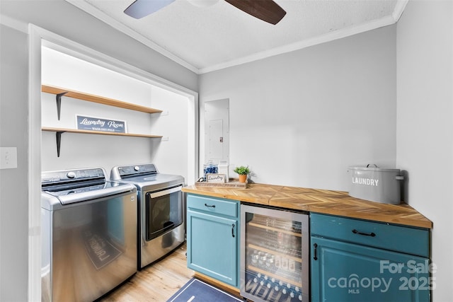 339 Deep Forest Ct, Gastonia, NC 28056 - washroom featuring wine cooler, crown molding, washer and clothes dryer, a ceiling fan, and light wood finished floors